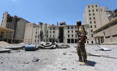 A Syria Democratic Forces (SDF) fighter walks in the silos and mills of Manbij after the SDF took control of it, in Aleppo Governorate, Syria.