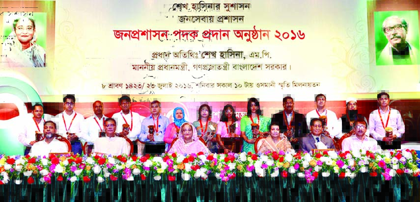 Prime Minister Sheikh Hasina poses for photograph with the recipients of Public Administration Medals at the medals distribution ceremony in Osmani Memorial Auditorium in the city on Saturday. BSS photo