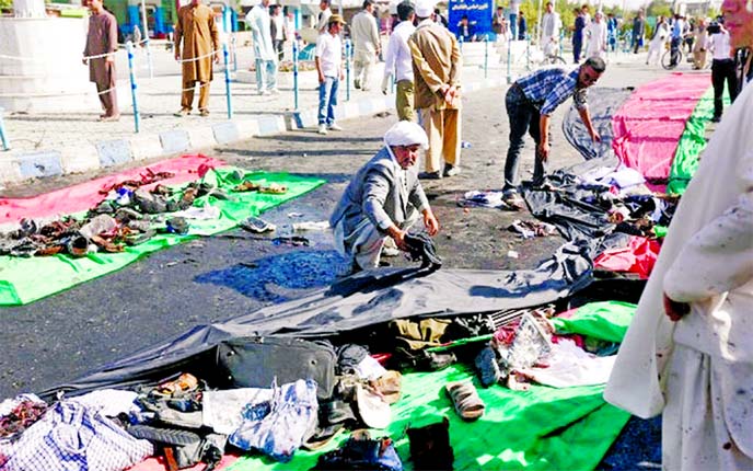 Afghan men remove the clothes of victims after a suicide attack in Kabul, Afghanistan on Saturday. Internet photo