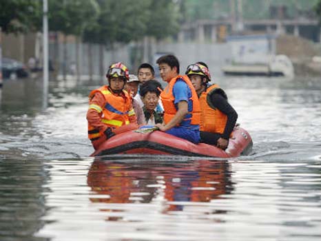 Rescuers use rafts to ferry people from flood-hit areas.