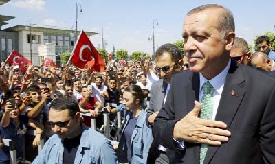 Turkish President Tayyip Erdogan acknowledges the crowd as he arrives at parliament.