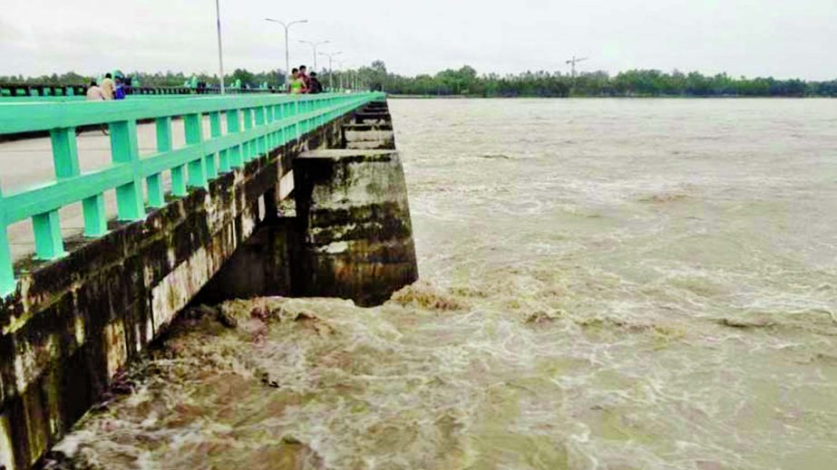 Incessant rains and onrush of flood water from the upstream flowing above danger level of Teesta Barrage. This photo was taken on Sunday.