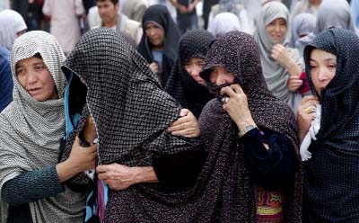 Afghan women mourn during the funeral of victims who died from a suicide attack, in Kabul, Afghanistan on Sunday.