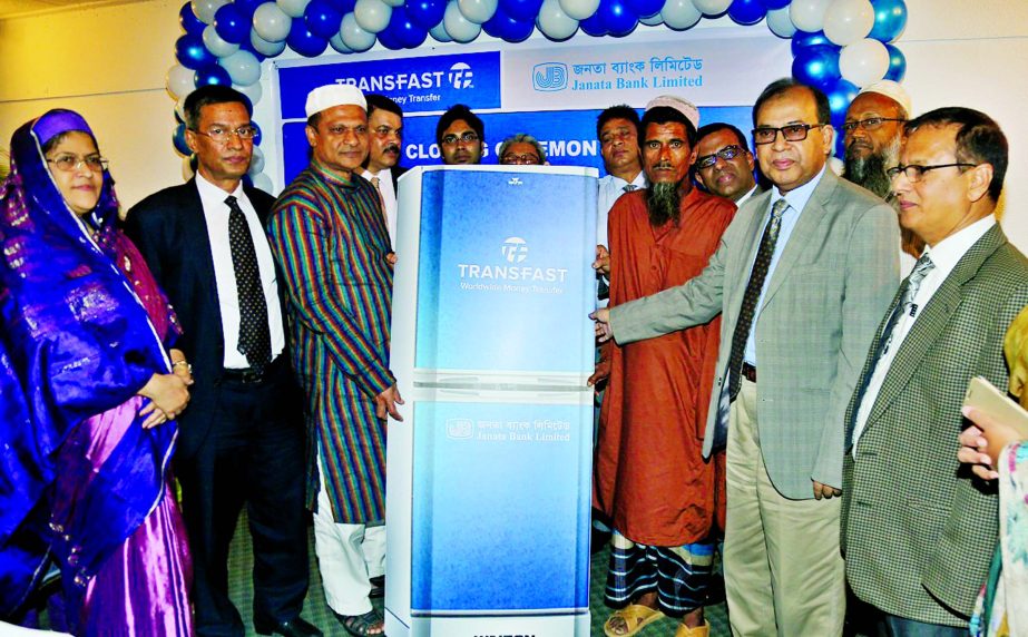 Md Mahabubur Rahman Hiron, Director and Md Abdus Salam, Managing Director of Janata Bank Ltd, presenting a refrigerator to the winners of a promotional programme at a city hotel on Monday. Afroza Gul Nahar and Md. Abdus Salam Azad, DMDs of the bank were