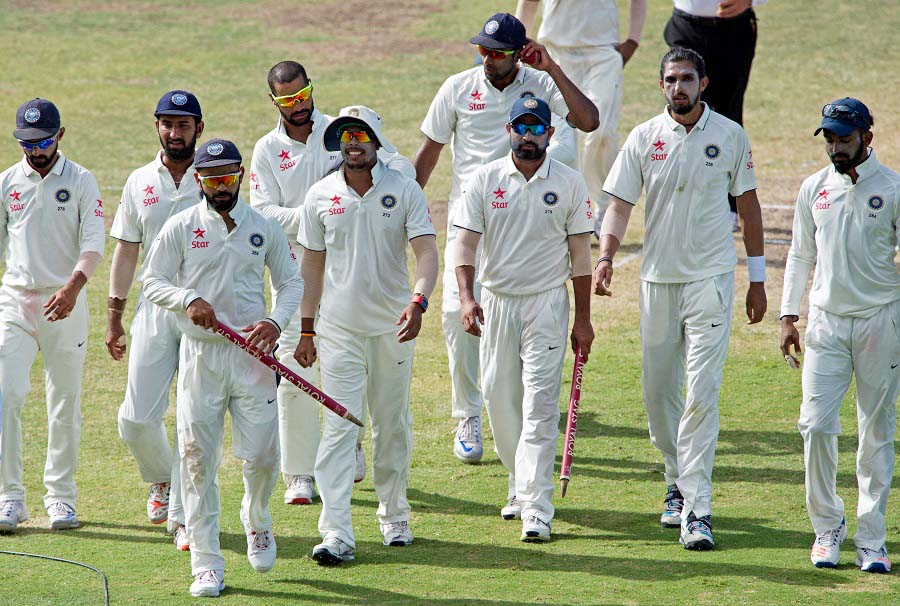 The Indian cricketer Virat Kohli walks off the field with teammates after day four of the cricket Test match between West Indies and India at Sir Vivian Richards Stadium in St John's, Antigua on Sunday.