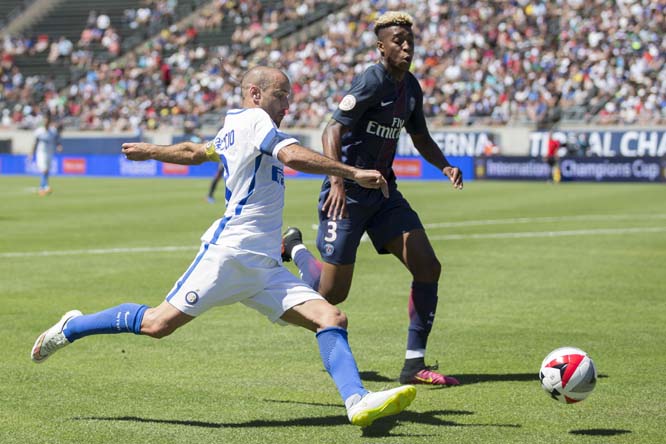 Inter Milan forward Rodrigo Palacio (8) (left) winds up to cross the ball under defensive pressure by Paris Saint-Germain defender Presnel Kimpembe (3) (right) during an International Champions Cup match in Eugene, Ore. on Sunday.