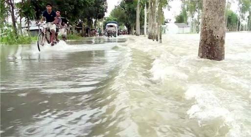 Kurigram-Bhurungamari highway inundated by flood water. This photo was taken from Maddhyakumarpur area on Tuesday.