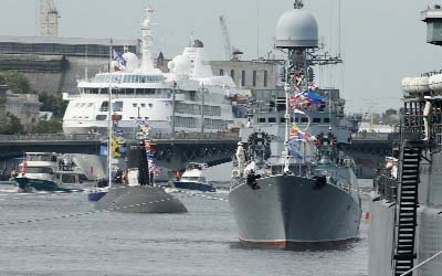 Photo shows Russian military ships and a submarine are moored at the Neva River during celebrating Navy Day in St.Petersburg, Russia.