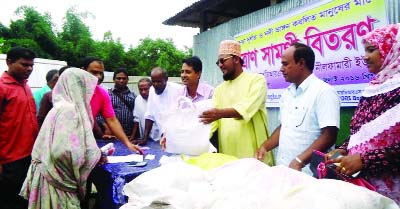 NILPHAMARI: Prof Mujibur Rahman, Vice - Chairman of Dimla Upazila distributing dry food of RDRS among the flood victims families at programme arranged at Tepakharibari Union Parishad Premises on Wednesday.