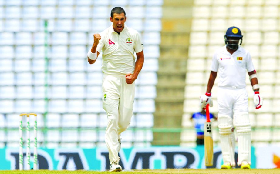 Australia's Mitchell Starc (left) celebrates the dismissal of Sri Lanka's Kusal Mendis as non striker Dilruwan Perera (right) watches on day four of their first Test cricket match in Pallekele, Sri Lanka on Friday.