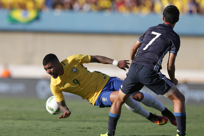 Brazil's Gabriel Barbosa (left) fights for the ball with Japan's Riki Harakawa, during a friendly soccer match between Brazil and Japan in preparation for the Olympic games, in Goiania, Brazil on Saturday.