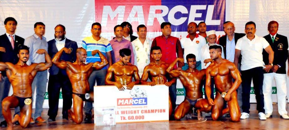The winners of the Marcel Cup Bodybuilding Competition with the guests and officials of Bangladesh Bodybuilding Federation pose for a photo session at the Auditorium of National Sports Council Tower on Sunday.
