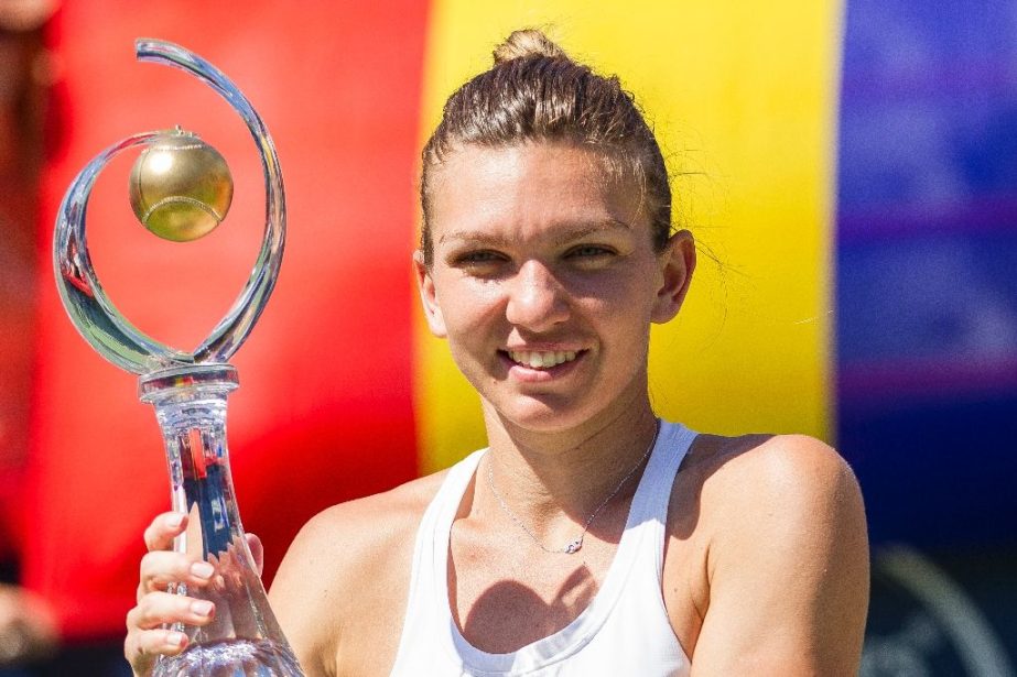 Simona Halep of Romania hoists the Rogers Cup after defeating Madison Keys of the United States in the final at Uniprix Stadium in Montreal, Quebec on Sunday.