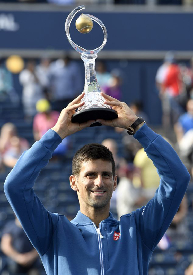 Novak Djokovic of Serbia holds aloft the trophy after a win over Kei Nishikori of Japan in the final of the Rogers Cup tennis tournament on Sunday in Toronto. Djokovic won 6-3, 7-5.