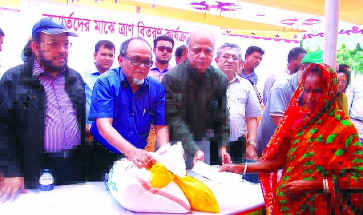 Engr. Mustafa Anwar, Chairman of Islami Bank Bangladesh Limited distributing relief among the flood affected people at the Haripur Char of Sundarganj Thana under Gaibandha district on Tuesday. Professor Syed Ahsanul Alam, Chairman, Executive Committee, Pr