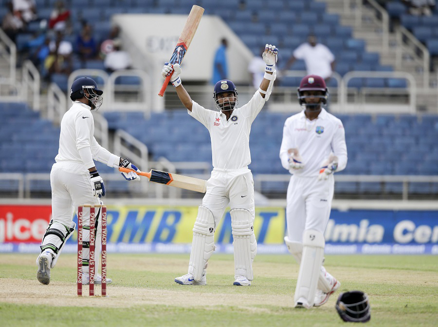 India's Ajinkya Rahane (center) celebrates after he scored a century as teammate Umesh Yadav (left) congratulates him during day three of their second cricket Test match at the Sabina Park Cricket Ground in Kingston, Jamaica on Monday.