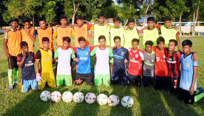 The participants of the football players' training programme pose for a photo session at Akkelpur Upazila ground in Joypurhat on Wednesday. Bangladesh Football Federation (BFF) has arranged the programme for development of district football.