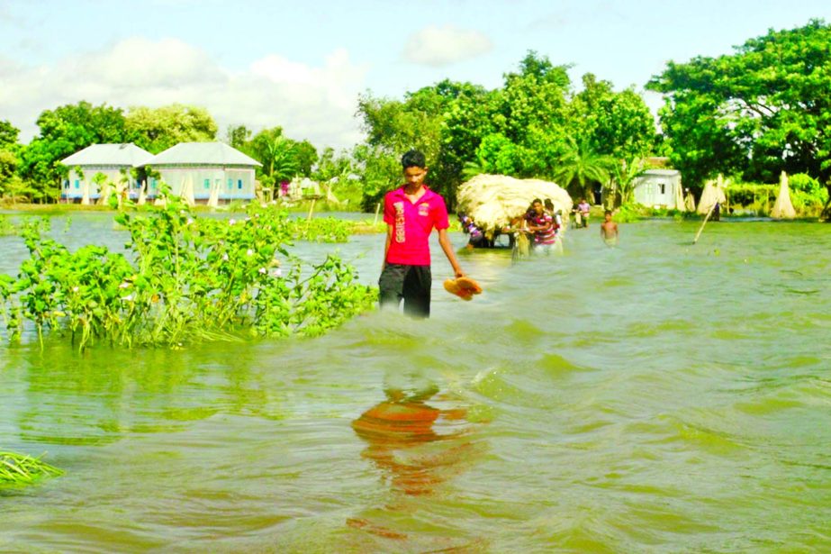 The main thoroughfare and fresh areas of Faridpur Sadar upazila inundated due to onrush of flood water. This photo was taken on Wednesday.