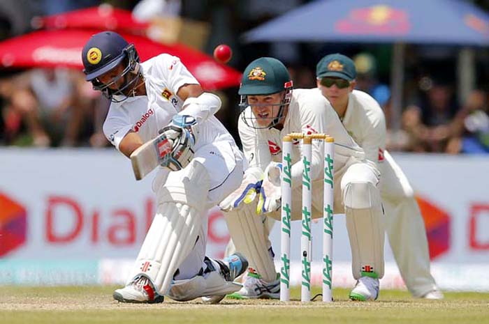 Sri Lanka's batsman Kusal Mendis plays a shot as Australia's wicketkeeper Peter Nevill and Steve Smith watch during the first day of their second cricket Test match in Galle, Sri Lanka on Thursday.