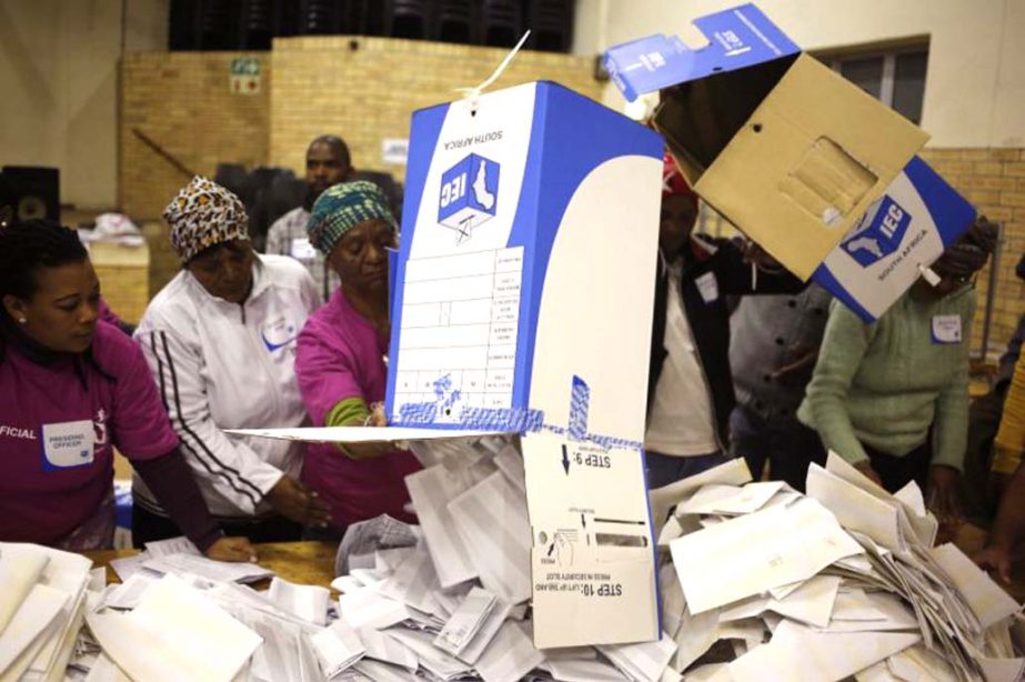 Election officials start the ballot counting process at a polling station during municipal elections in Manenberg on the outskirts of Cape Town.