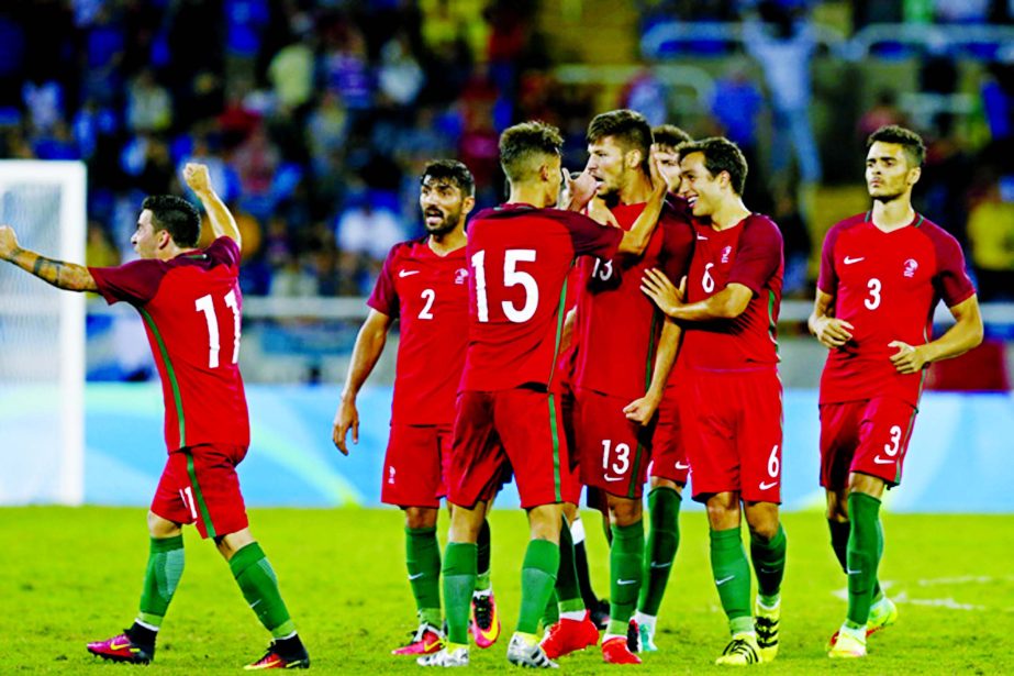 Portugal's Pite, 13, is congratulated after scoring his side's 2nd goal during a group D match of the men's Olympic football tournament between Portugal and Argentina at the Rio Olympic Stadium in Rio De Janeiro, Brazil on Thursday.