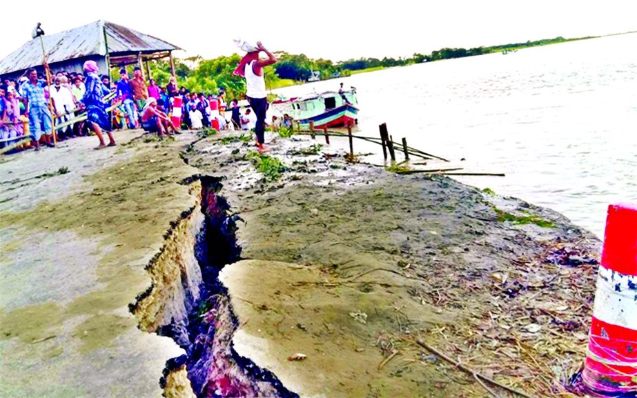As flood water receding fast, Padma River erosion has taken a serious turn where thousands of people passing their days in panic. This photo was taken from Shariatpur point on Friday.