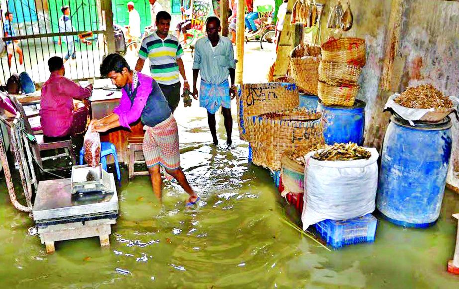 The Port City's Khatunganj market wholesalers sufferings mount as tidal waters enter the market. This photo was taken on Friday.