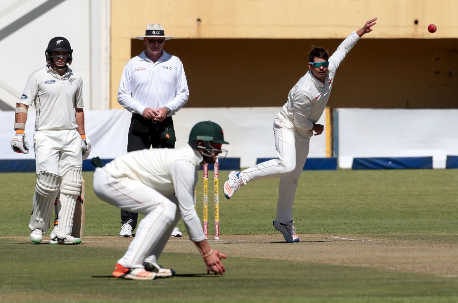 Zimbabwe's captain Graeme Cremer (R) bowls during the first day of the second Test in a series of two matches, where New Zealand lead hosts Zimbabwe 1-0, at the Queens Sports Club in Bulawayo on Saturday.