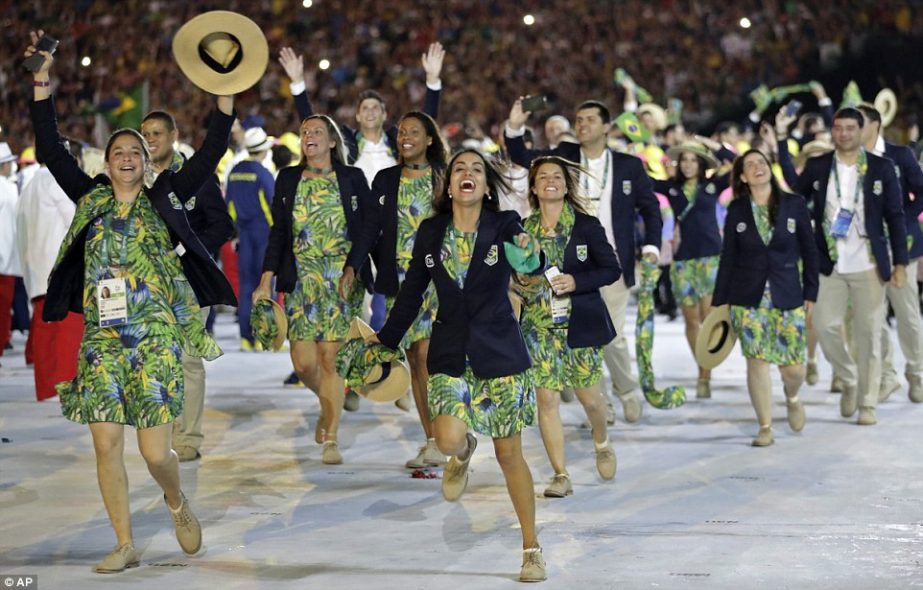Members of team Brazil run in the arena during the opening ceremony on Saturday morning.