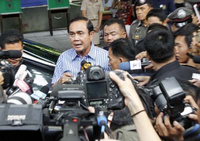 Tha Prime Minister Prayuth Chan-ocha talks to reporters after casting his vote in a referendum on a new constitution at a polling station in Bangkok on Sunday.