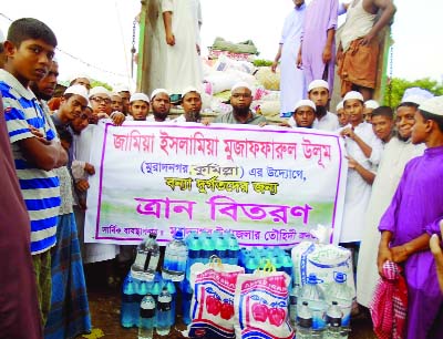 COMILLA: Relief goods distributed by Jamiya Islamia Mujaffarul Ulum Madrasa in Muradnagar on Saturday.