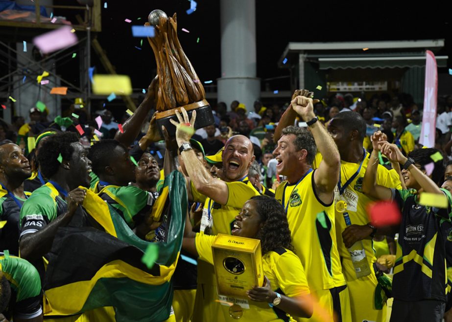Tallawahs players and coaching staff hold the CPL trophy aloft after the final of CPL 2016 at St Kitts on Sunday.