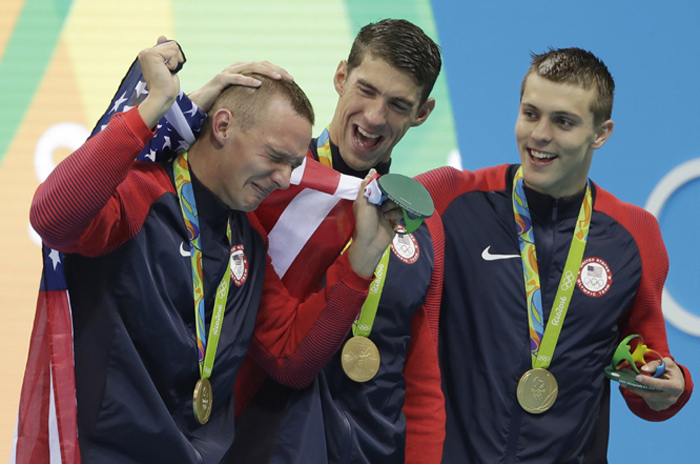 Caeleb Dressel (left) Michael Phelps and Ryan Held (right) from the United States celebrate after winning the gold medal in the men's 4x100-meter freestyle relay during the swimming competitions at the 2016 Summer Olympics on Sunday in Rio de Janeiro, Br