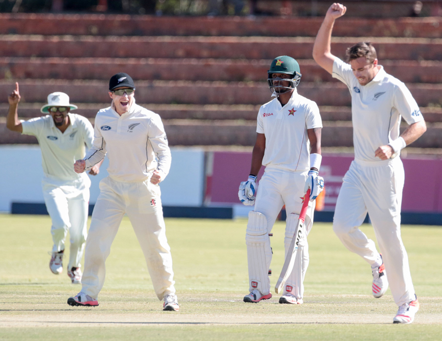 New Zealand's bowler Tim Southee (R) celebrates a wicket during the third day of the second Test cricket match between New Zealand and Zimbabwe at the Queens Sports Club in Bulawayo on Monday.