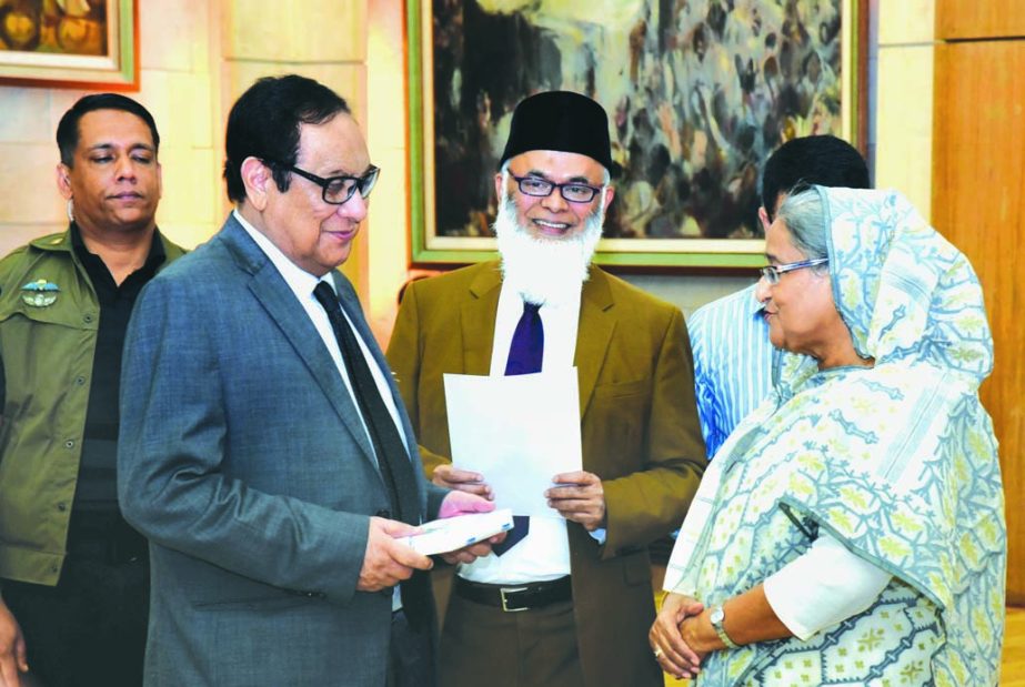Prime Minister Sheikh Hasina is receiving a cheque of Tk.7.50 million for "Prime Minister's Relief Fund" as donation for the flood victims from A Rouf Chowdhury, Chairman of Bank Asia at a function held at the Gonobhabon on Tuesday.