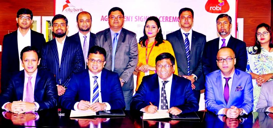 City Bank Ltd signs a deal with Robi Axiata Limited in the city on Tuesday. Under the agreement, Robi customers will enjoy up to 50 percent savings on 1st year Annual Fees on City Bank American Express Credit Cards. Sohail R. K. Hussain, MD & CEO, City B
