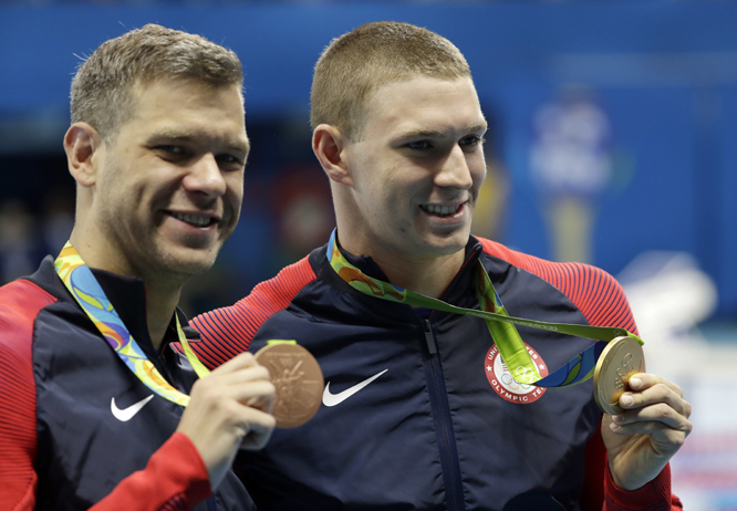 Winner United States' Ryan Murphy (right) and third placed United States' David Plummer celebrate with their medals after the men's 100-meter backstroke at the swimming competitions at the 2016 Summer Olympics in Rio de Janeiro, Brazil on Monday.