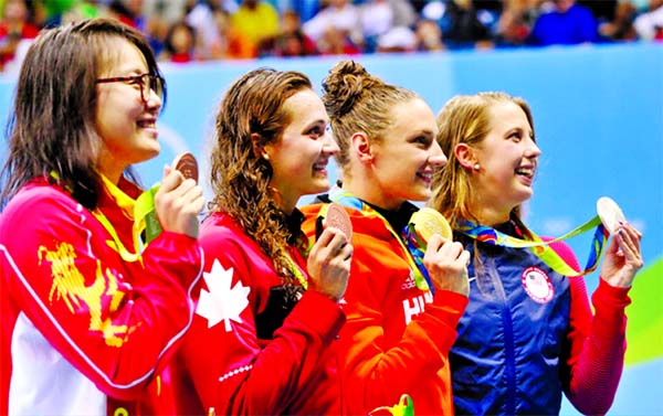 Winner Hungary's Katinka Hosszu (second left) second place United States' Kathleen Baker (left ) and joint third place China's Fu Yuanhui (right) and Canada's Kylie Masse during the medal ceremony after the final of the the women's 100-meter backstro