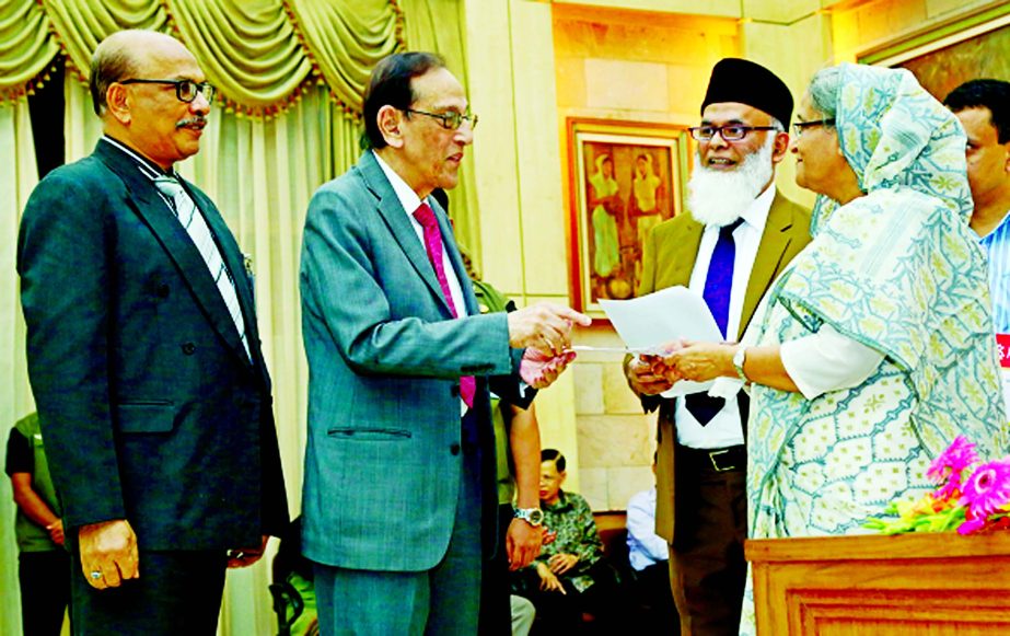 ONE Bank's Vice Chairman Asoke Das Gupta and Director Shawkat Jaman are seen handing over a cheque of Tk. 15 million to the Prime Minister Sheikh Hasina as donation to the Prime Minister's Relief Fund at Ganobhaban on Wednesday.