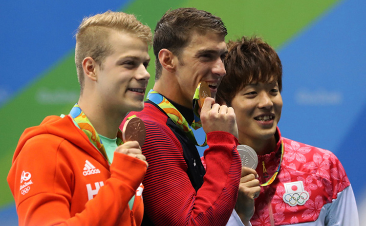 Winner United States' Michael Phelps (center) second placed Japan's Masato Sakai (right) and third placed Hungary's Tamas Kenderesi hold up their medals after the men's 200-meter butterfly during the swimming competitions at the 2016 Summer Olympics o