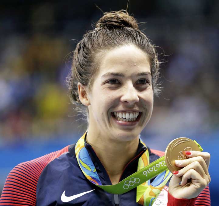 United States' Maya DiRado holds up her gold medal in the women's 200-meter backstroke medals ceremony during the swimming competitions at the 2016 Summer Olympics on Friday in Rio de Janeiro, Brazil.