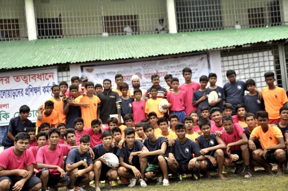 The participants of the rugby under-16 training programme and the officials of Madaripur District Sports Association and the officials of National Sports Council pose for a photo session at Madaripur on Friday.