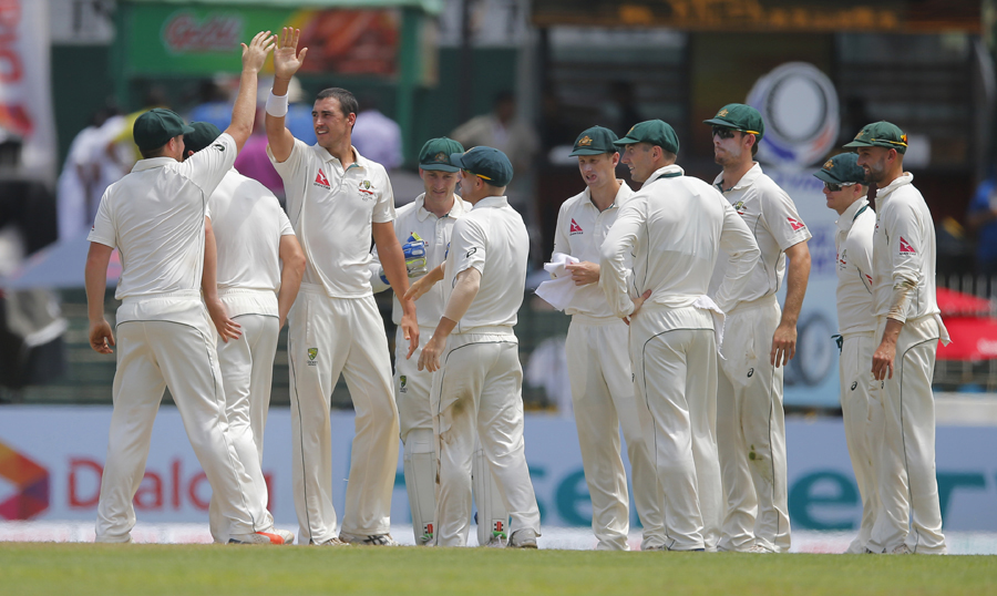 Australia's Mitchell Starc (third left) celebrates the wicket of Sri Lanka's Dimuth Karunaratne (unseen) with team mates during the day one of their third Test cricket match in Colombo, Sri Lanka on Saturday.