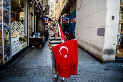 A vendor sells Turkish national flags on Istiklal Avenue in Istanbul.