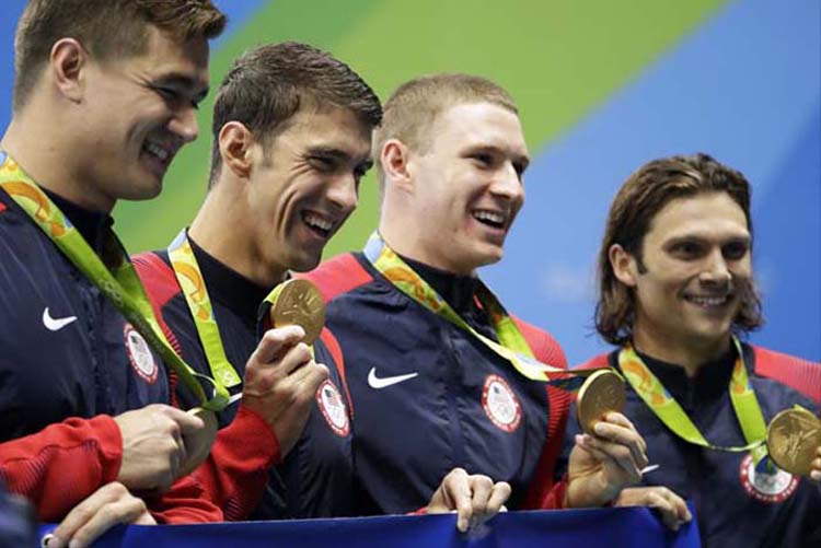From right to left, United States' Cody Miller, Ryan Murphy, Michael Phelps and Nathan Adrian display their medals during the medal ceremony for the men's 4 x 100-meter medley relay final in the swimming competitions at the 2016 Summer Olympics in Rio d