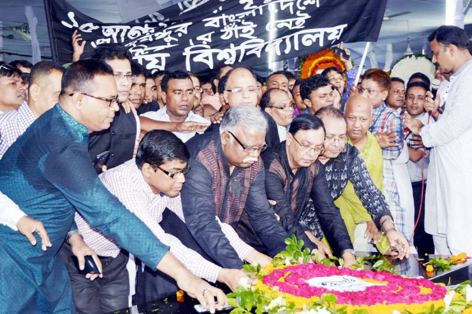 Vice-Chancellor of National University Prof Dr Harun-Or-Rashid along with its Pro-Vice Chancellor Prof Dr Hafiz Md. Hasan Babu, Treasurer Prof Md. Noman Ur Rashid, Registrar, departmental heads, teachers, officers and employees are seen giving floral wrea