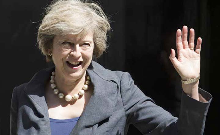 British Prime Minister Theresa May weaving hands to party men before speaking.