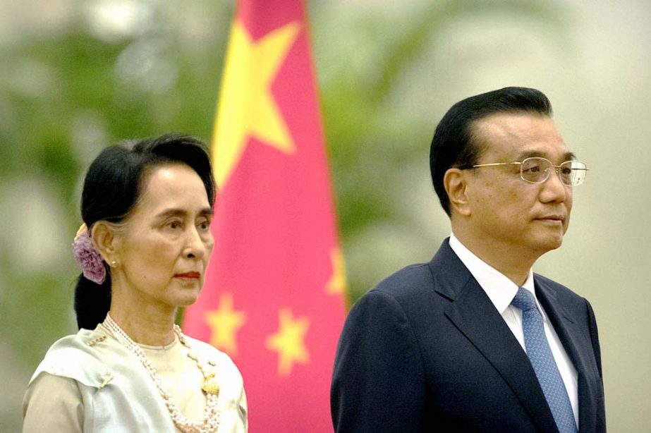 Myanmar's State Counsellor Aung San Suu Kyi, left, and China's Premier Li Keqiang, right, stand during a welcome ceremony at the Great Hall of the People in Beijing on Thursday.