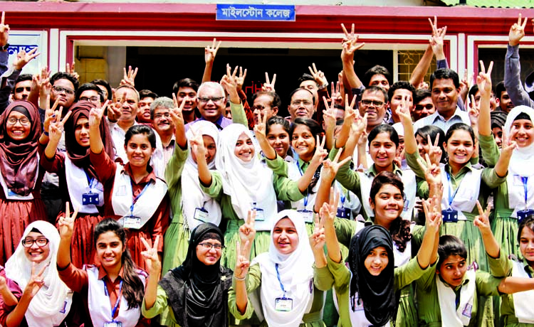 Teachers and students of the city's Milestone College showing victory (V) sign after getting result of HSC examination on the college premises on Thursday.