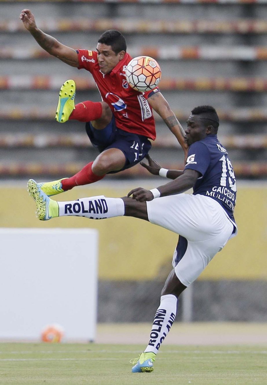 Luis Arias of Colombia's Independiente Medellin (left) fights for the ball with Jordy Caicedo of Ecuador's Universidad Catolica during Copa Sudamericana match in Quito, Ecuador on Wednesday.